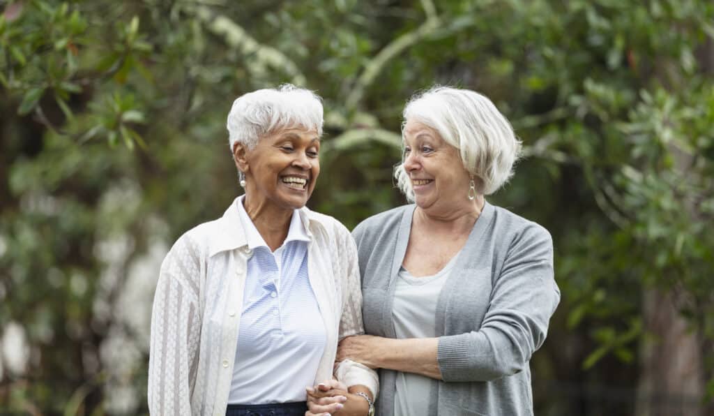 Two senior women walking and talking