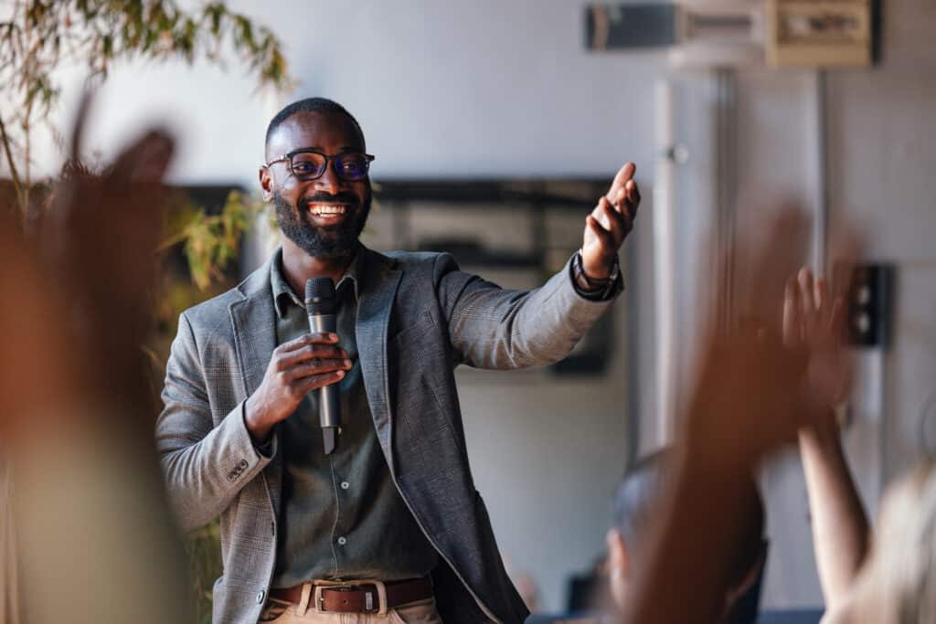 Smiling Speaker Engaging with Audience