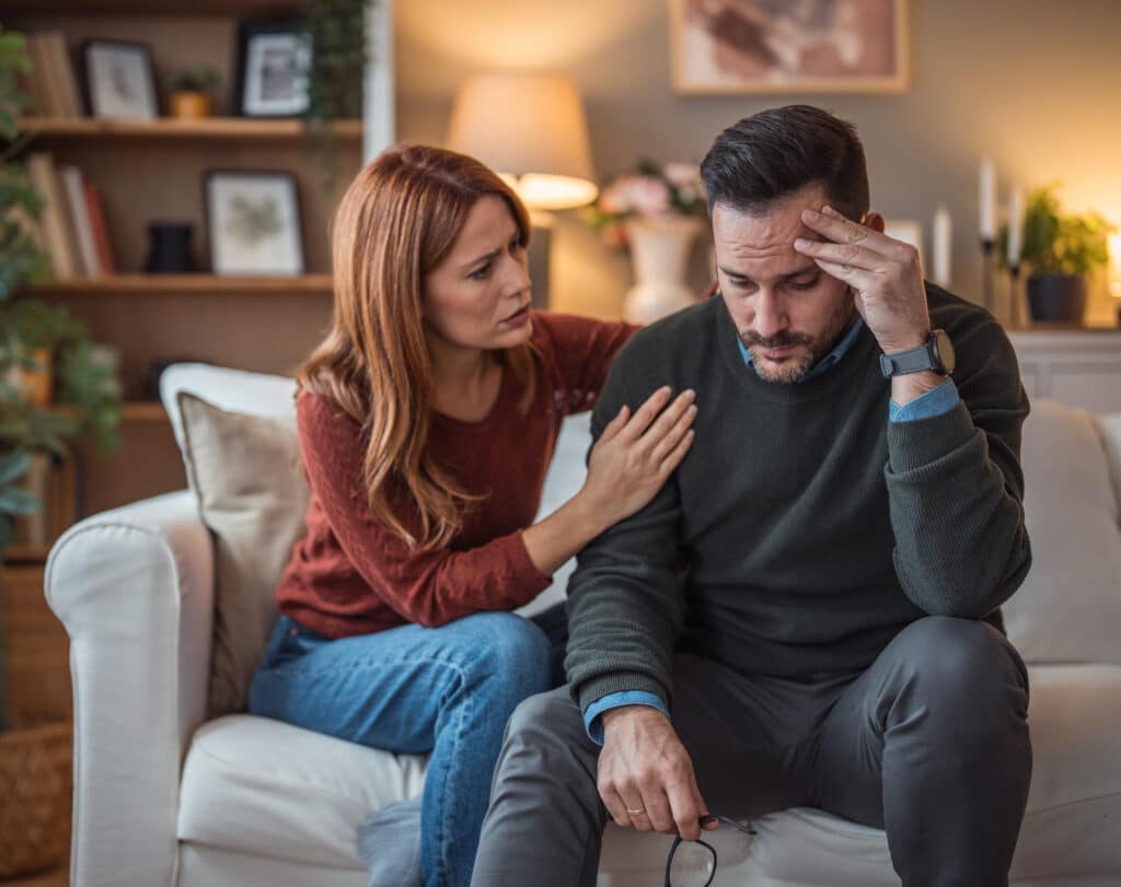 A woman comforts her depressed partner