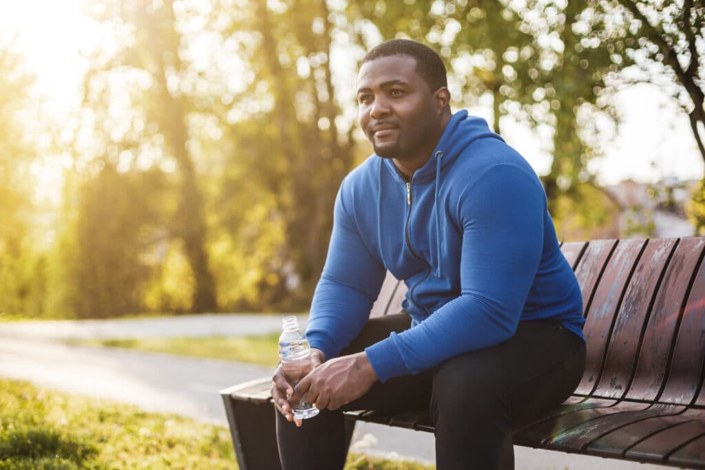 Man resting after exercise and drinking water