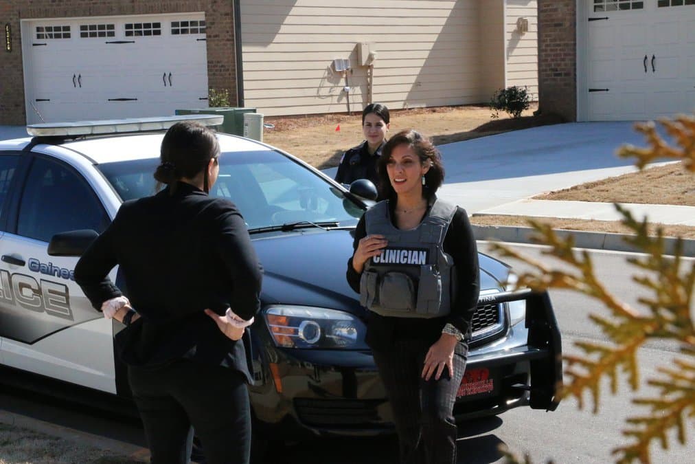 gainesville pd mental health clinicians standing outside beside police car