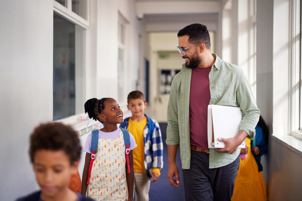 Teacher talking with a student in school