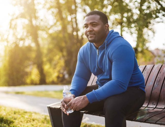 Man resting after exercise and drinking water
